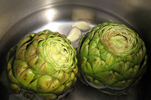 two artichokes in a pan