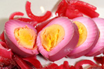 beet pickled eggs on a plate with pickled beets and onions