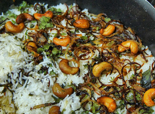 biryani with rice, cashew nuts, fried onions and herbs