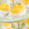 deviled eggs on a tiered plate