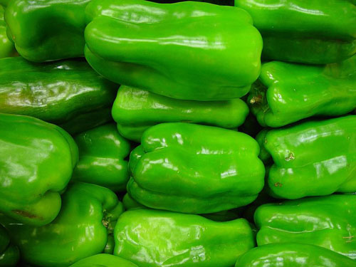 pile of shiny green bell peppers