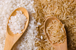 white rice and brown rice and in wooden spoons