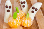 three tangerine pumpkins and three banana ghosts