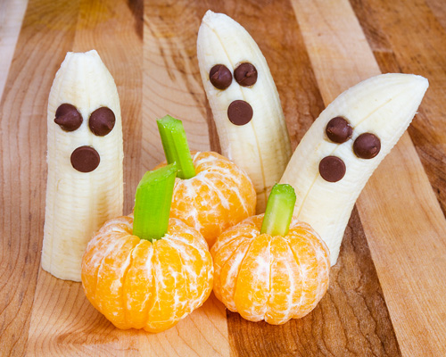 three tangerine pumpkins and three banana ghosts