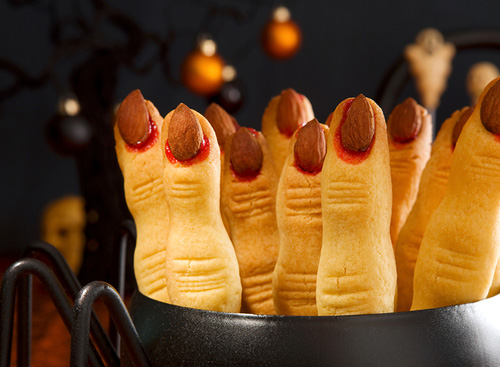 ten witches fingers cookies standing upright in a black kettle