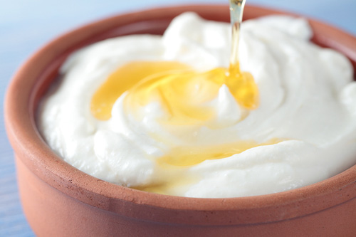 plain yogurt with honey in a terracotta bowl