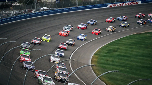 race cars on a track at a NASCAR auto racing event 